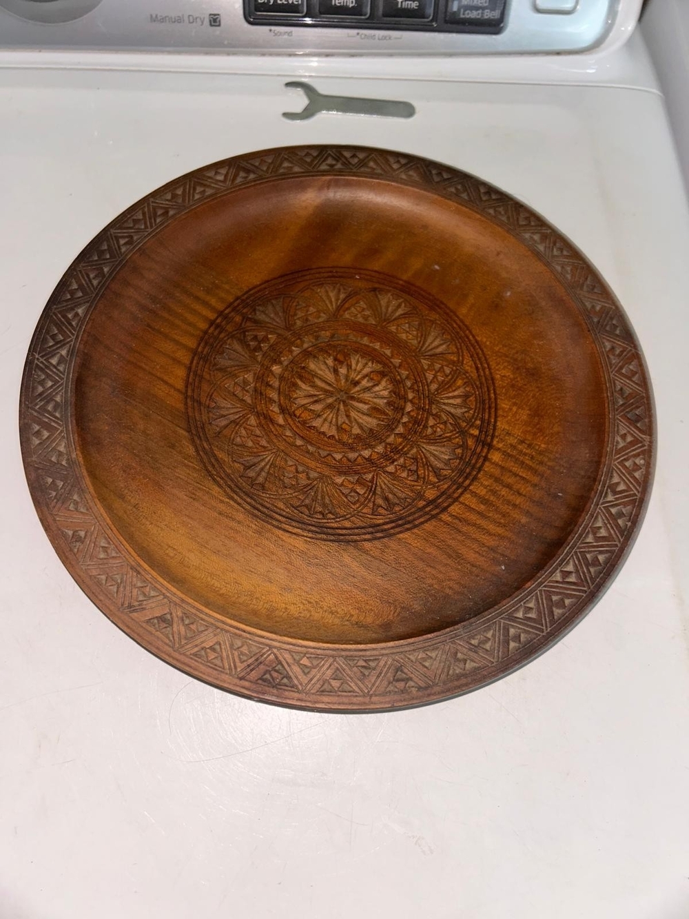 vintage hand-carved wooden plate is a characteristic piece of European folk